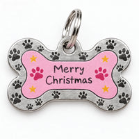 Close-up of a bone-shaped metal pet tag with a pink center, paw-print border, small yellow stars and a split ring. 3