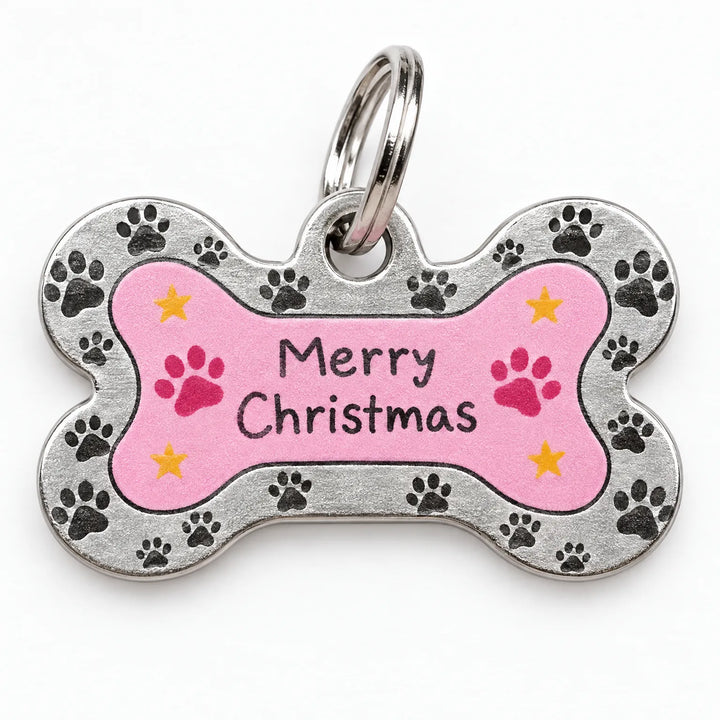 Close-up of a bone-shaped metal pet tag with a pink center, paw-print border, small yellow stars and a split ring. 3