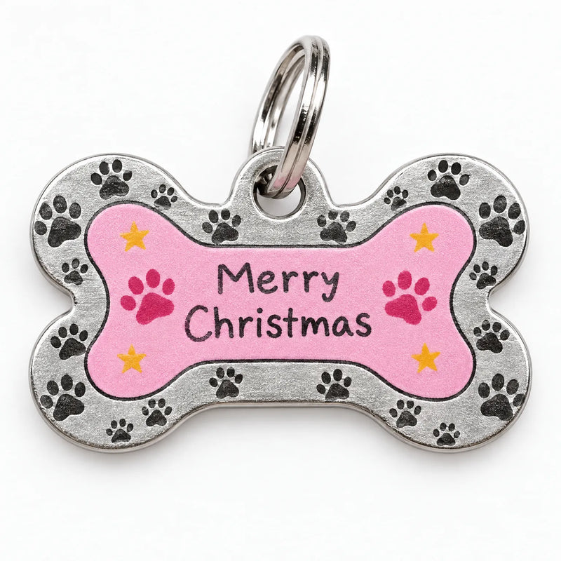 Close-up of a bone-shaped metal pet tag with a pink center, paw-print border, small yellow stars and a split ring. 3
