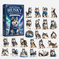 Dark blue boxed calendar with a northern lights scene, laid out with 24 husky ornaments in blue winter gear and sleeping poses. 3