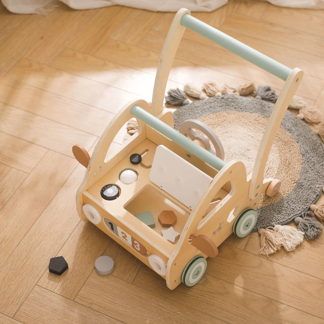 Wooden push-along walker with Montessori play components and mirrors.