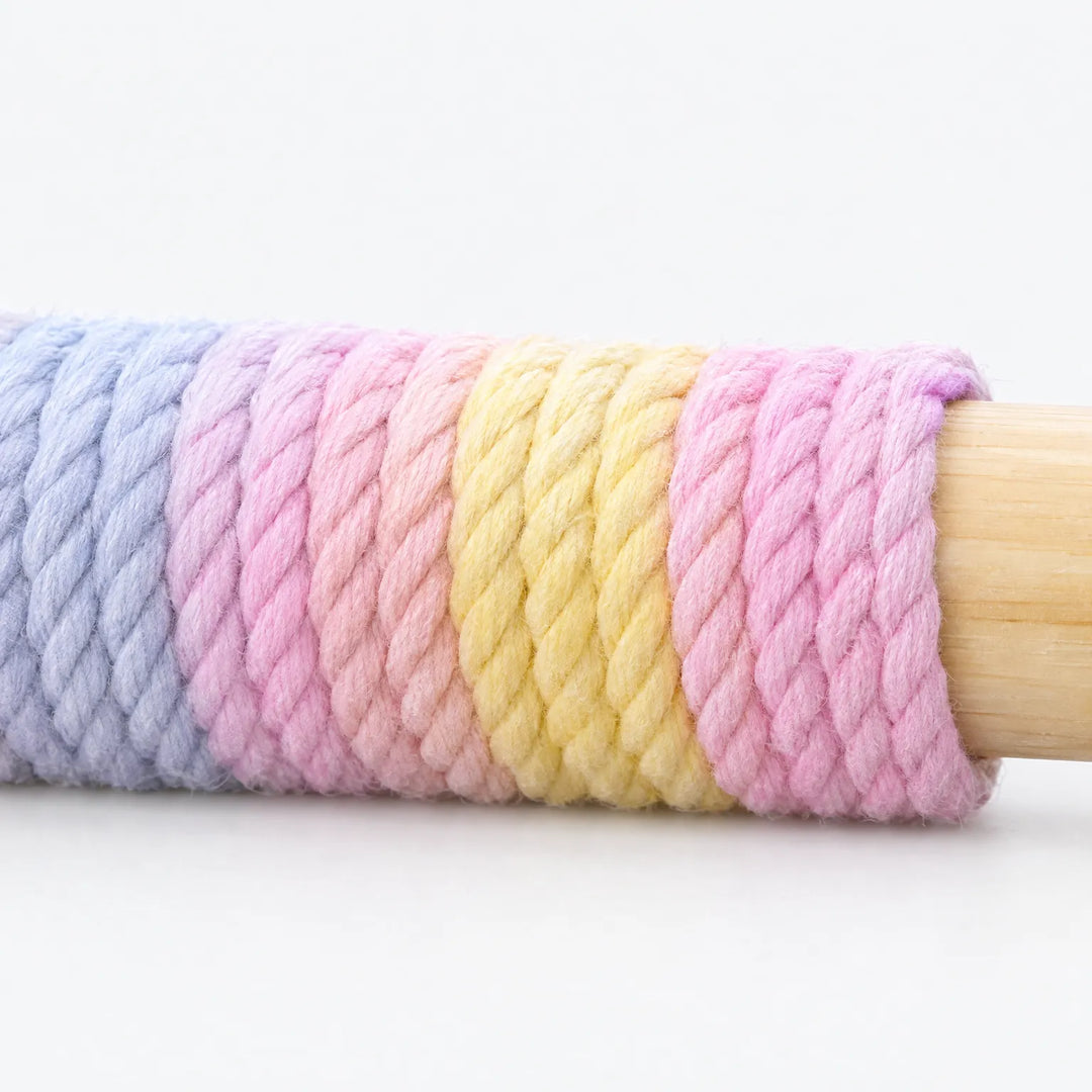 Close-up of the pastel pink, yellow and blue twisted rope wrapped tightly around the wooden perch bar. 3