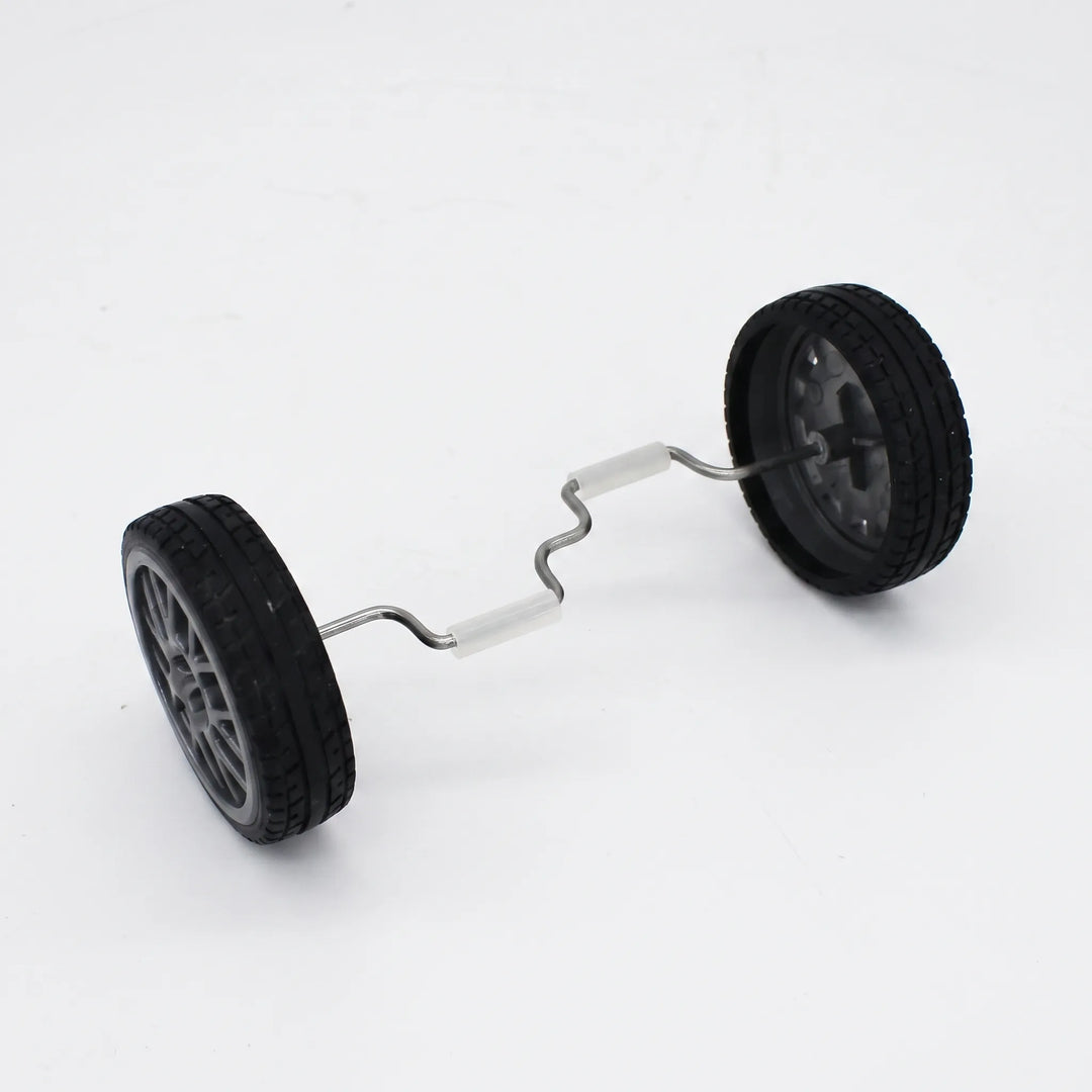 Two black rubber-tyred wheels joined by a bent metal axle with white grip sleeves, shown on its own against a plain background. 1