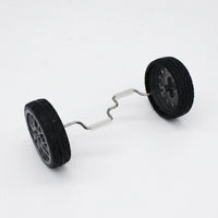 Two black rubber-tyred wheels joined by a bent metal axle with white grip sleeves, shown on its own against a plain background. 1