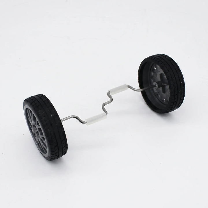 Two black rubber-tyred wheels joined by a bent metal axle with white grip sleeves, shown on its own against a plain background. 1