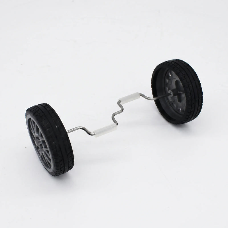 Two black rubber-tyred wheels joined by a bent metal axle with white grip sleeves, shown on its own against a plain background. 1