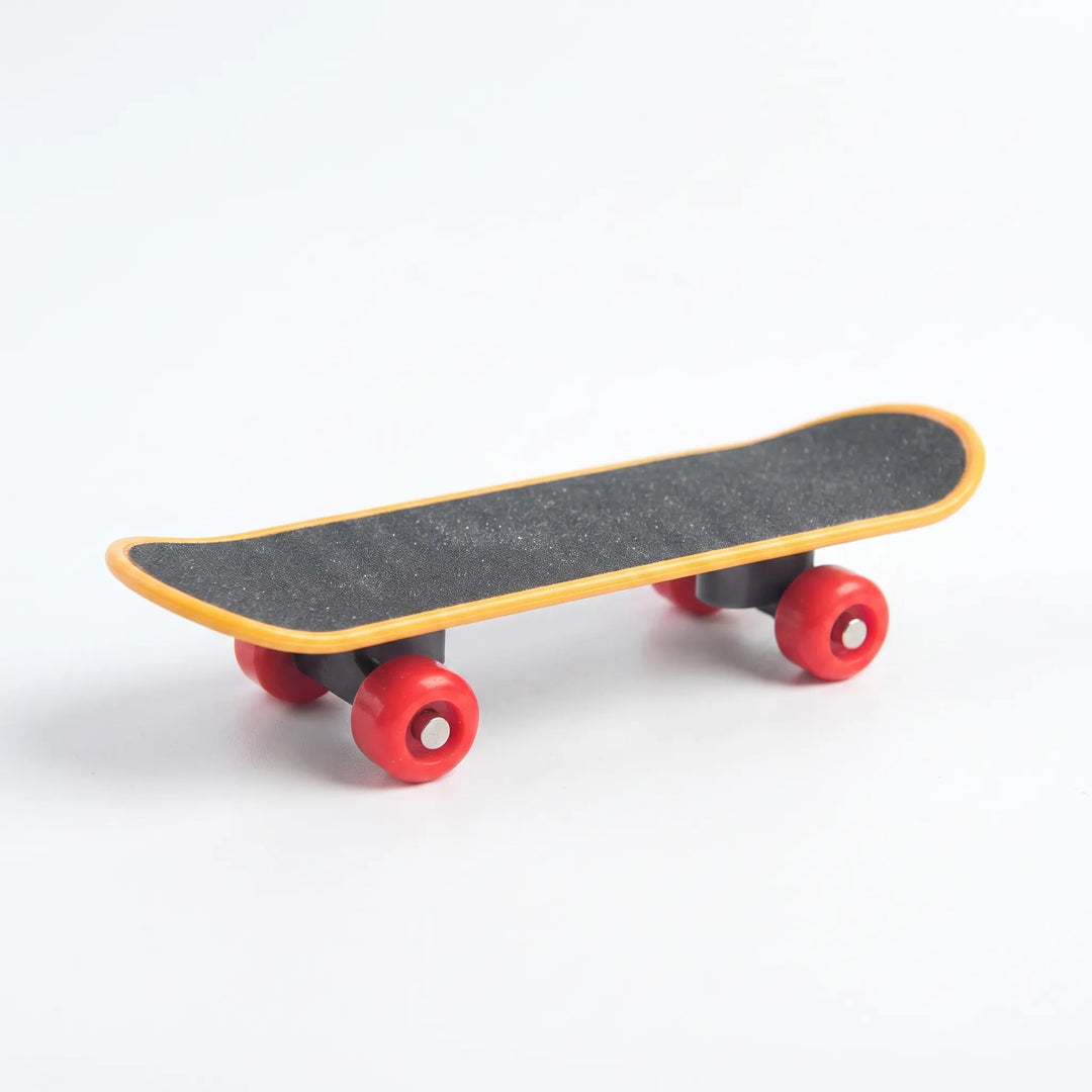 Miniature skateboard toy with a gritty black deck, orange edging and four red wheels, shown on a plain white background. 1