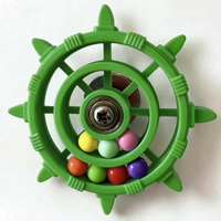 Green version of the wheel toy with a metal bearing hub and seven coloured balls in the lower rings. 7