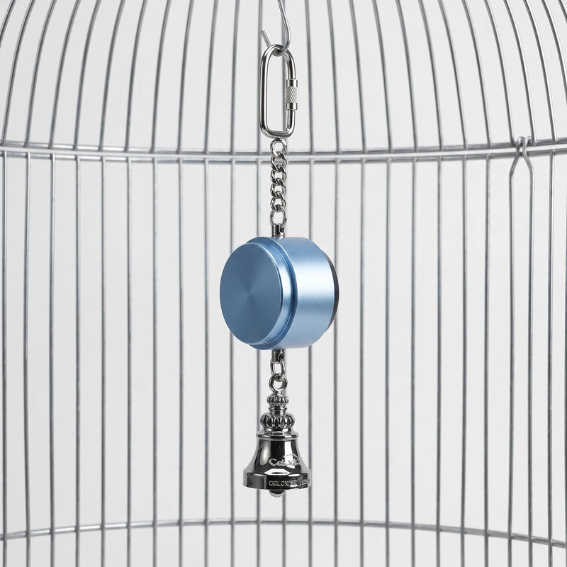 Blue metal cylinder with a silver bell below and a chain and carabiner above, hanging from the bars of a bird cage. 1