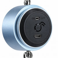 Close-up of the open back of the blue cylinder, showing the on/off slider, record button and USB-C charging port. 3
