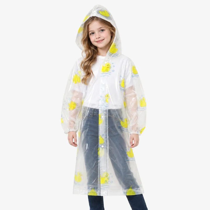 Front view of a smiling girl wearing a clear hooded raincoat with yellow rubber ducks, elastic cuffs and snap buttons. 4