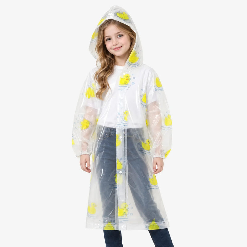 Front view of a smiling girl wearing a clear hooded raincoat with yellow rubber ducks, elastic cuffs and snap buttons. 4