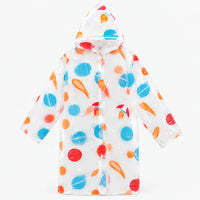 Flat lay of the clear hooded raincoat with a space print of blue and red planets, orange comets and small rockets. 8