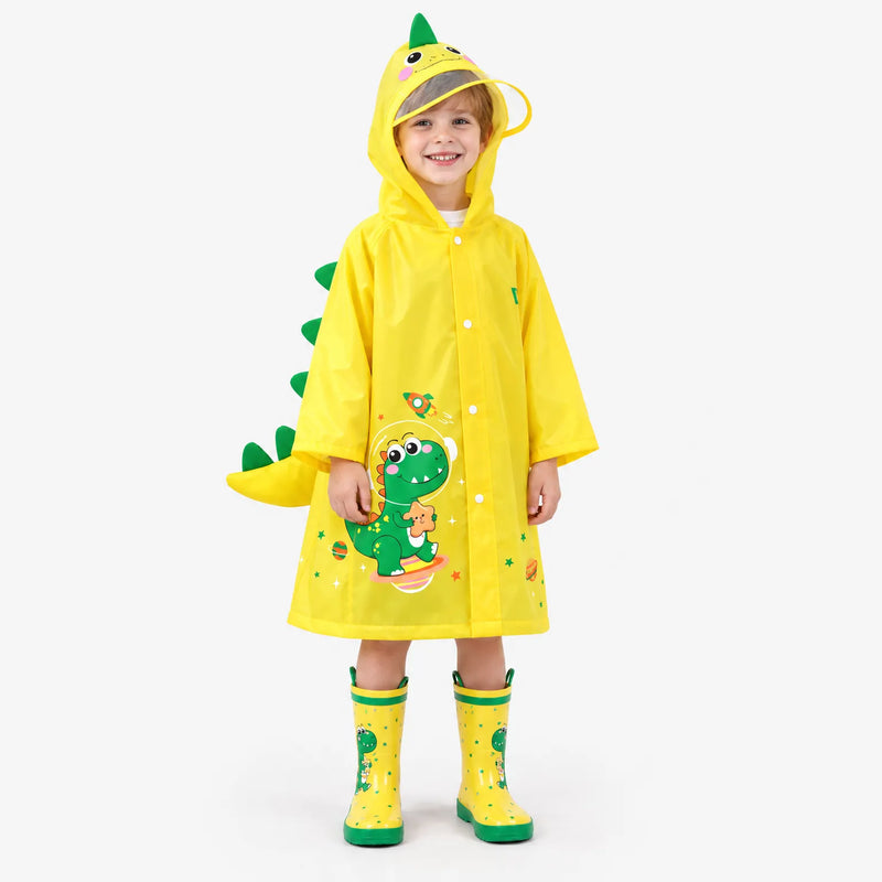 Smiling boy wearing a yellow dinosaur raincoat with green spikes and tail, clear hood brim and matching dinosaur rain boots. 2