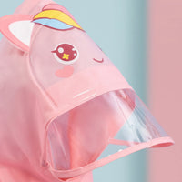 Close-up of the pink unicorn hood with ears, rainbow horn, big eyes and a transparent visor brim. 6