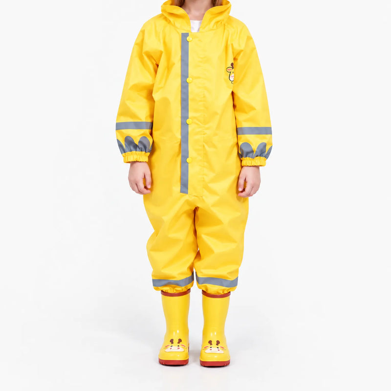 Front view of a child in the yellow hooded rain jumpsuit with grey reflective stripes, snap buttons, elastic cuffs and giraffe boots. 2