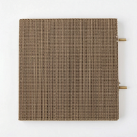 Top-down view of the square cardboard platform with two threaded metal fixing bolts protruding from one side. 5