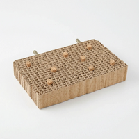 Thick rectangular cardboard platform with cork stoppers inserted into the cells and two threaded bolts at the back. 8