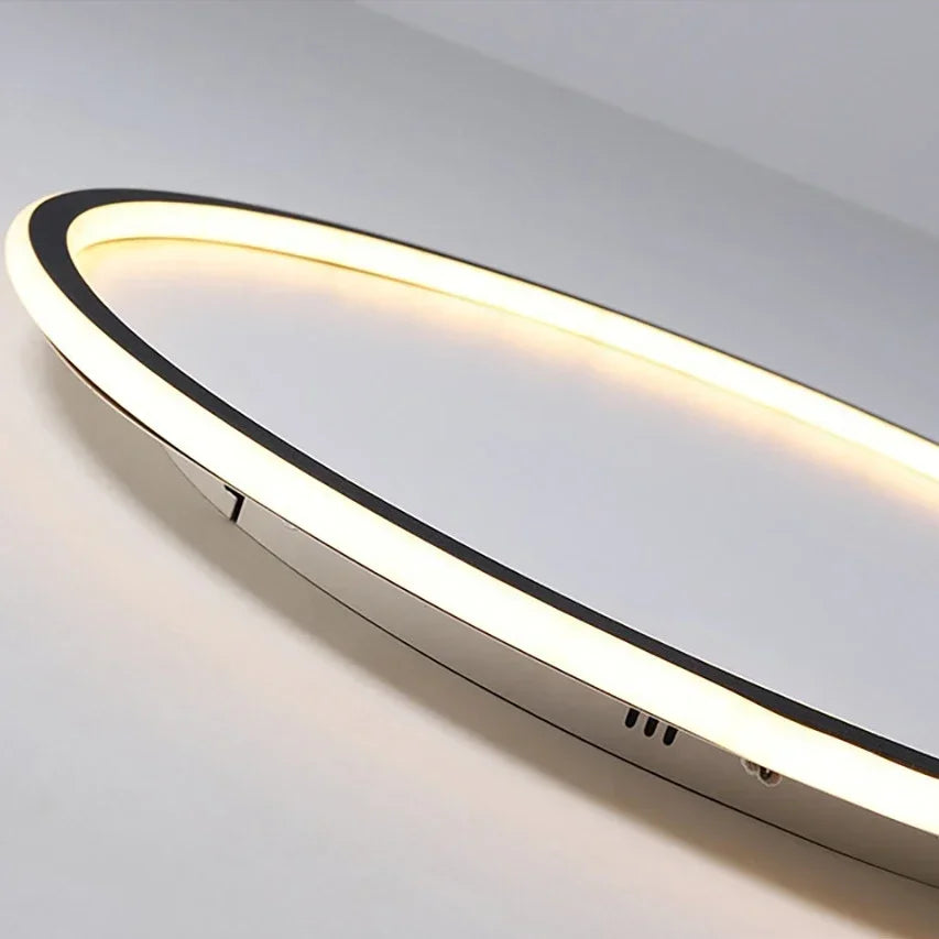 Close-up of the glowing edge of a ring-shaped ceiling light, showing its black rim and slim side profile 6