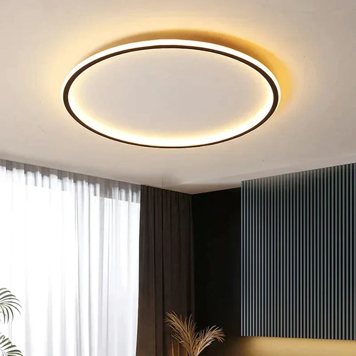 Slim round ceiling light with a black rim, glowing warm white in a room with dark panelling 2