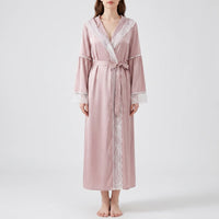 Front view of a model in the pink satin robe tied with a bow, lace running down the front opening. 6