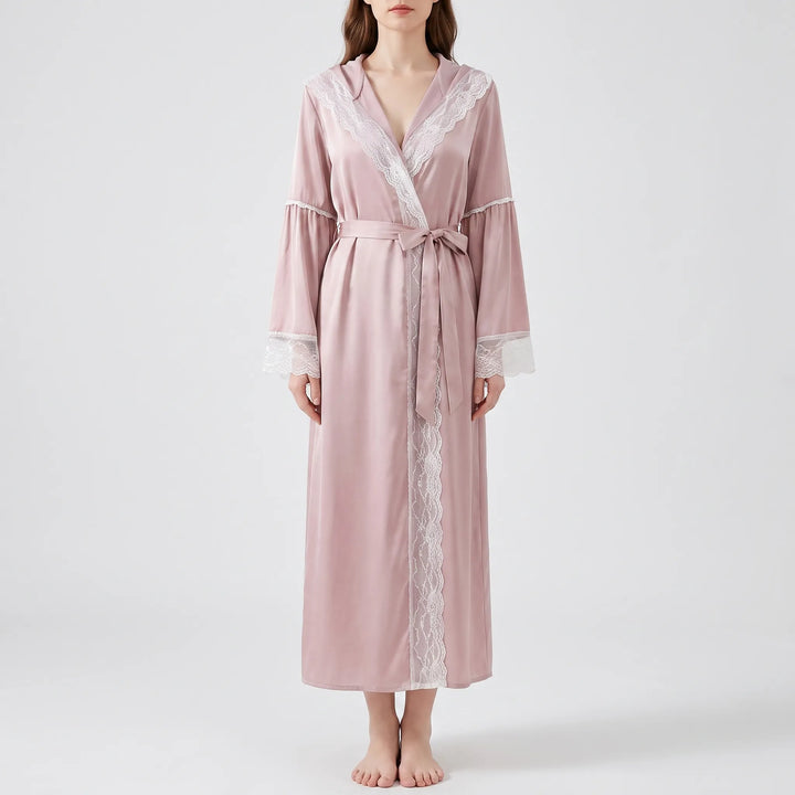 Front view of a model in the pink satin robe tied with a bow, lace running down the front opening. 6