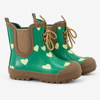 Pair of green rubber ankle boots with pale heart print, tan lace-up front, elastic side gusset, pull tab and chunky lugged sole. 2