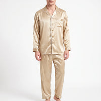 Front view of a model wearing the pyjama set in a light gold satin with cream piping and matching buttons. 8
