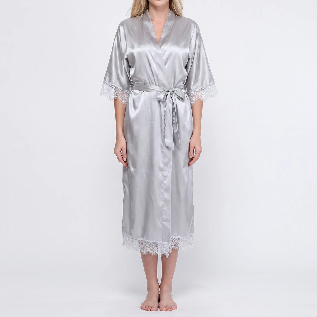Model wearing the silver-grey satin robe with white lace on sleeves and hem, belted at the waist, front view. 6