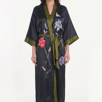 Black satin robe with olive green trim and belt, decorated with embroidered-look flowers and a butterfly. 10