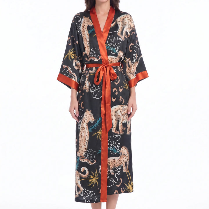 Black satin robe with leopard and tropical leaf print, finished with bright orange trim and an orange tie belt. 8
