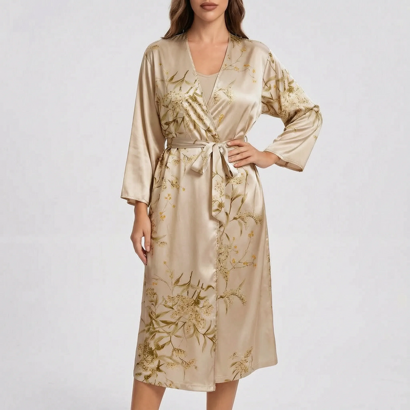 Model wearing the robe in a champagne-gold satin with soft olive floral print, tied at the waist. 6
