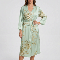 Model wearing the robe in a pale mint-green satin with golden floral print, belted at the waist. 8