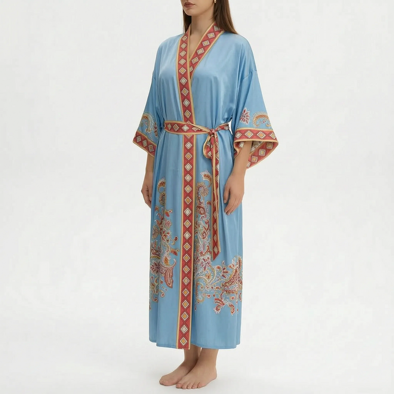 Model wearing the long wrap robe in sky blue with a red diamond-pattern border and paisley motifs on the skirt and sleeves. 13
