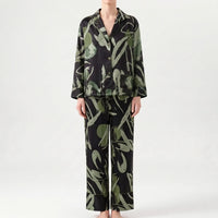 Front view of the pyjama set in a black and green abstract print colourway, with chest pocket and wide-leg trousers. 6