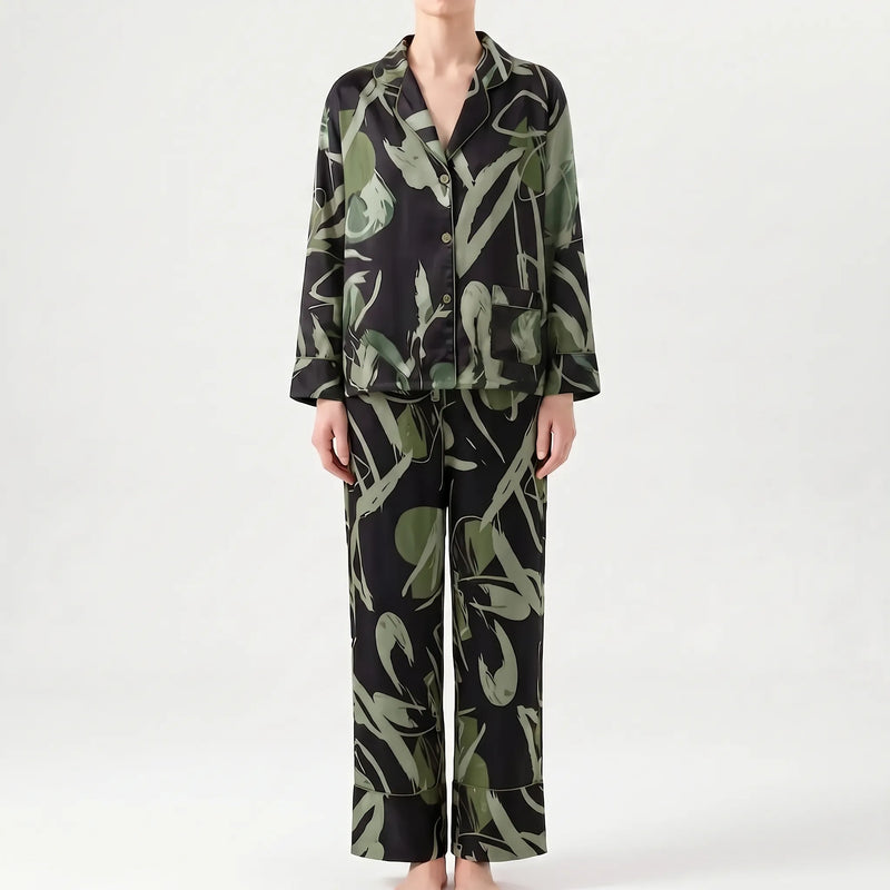 Front view of the pyjama set in a black and green abstract print colourway, with chest pocket and wide-leg trousers. 6