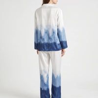 Back view of the model wearing the ombre pyjama set, showing the white-to-navy gradient across the shirt and wide-leg trousers. 3