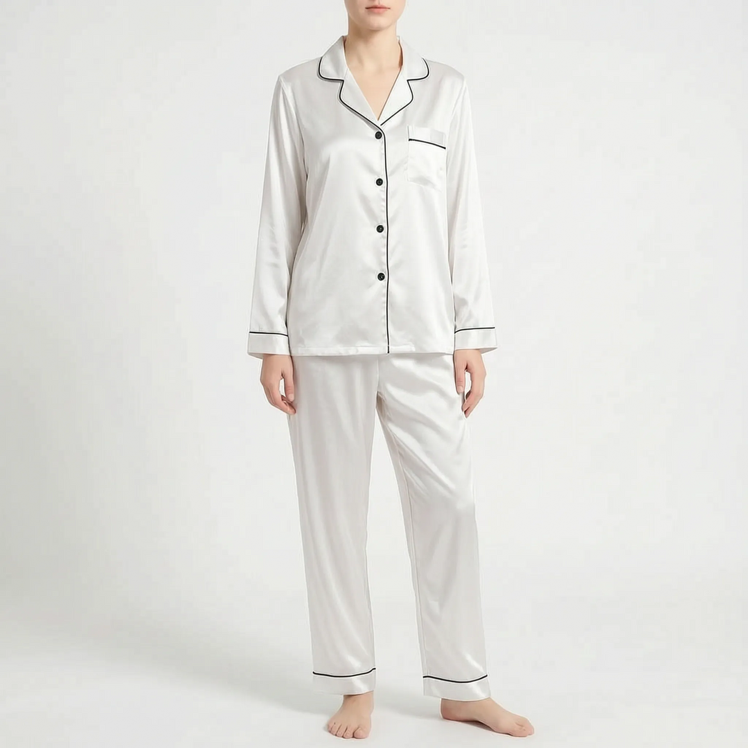 Front view of the white satin pyjama set with black piping and black buttons, worn by a model. 6