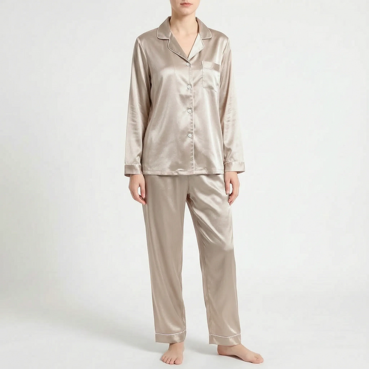 Front view of the champagne-beige satin pyjama set with light piping and pale buttons, worn by a model. 7