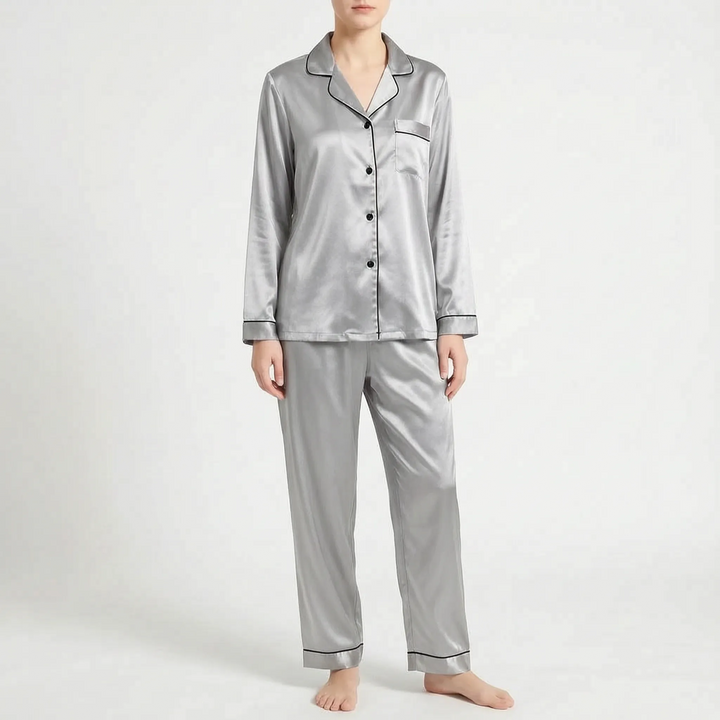 Front view of the grey satin pyjama set with black piping and black buttons, worn by a model. 9