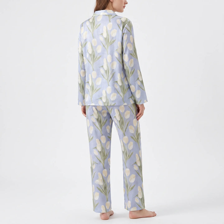 Back view of the blue pyjama set, showing the continuous cream tulip print on the long-sleeved top and straight trousers. 3