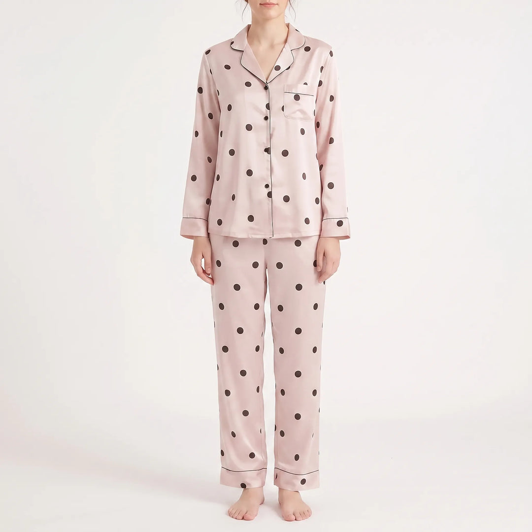 Another colourway for comparison: pink satin pyjama set with dark polka dots and dark piping, worn by a model from the front. 6