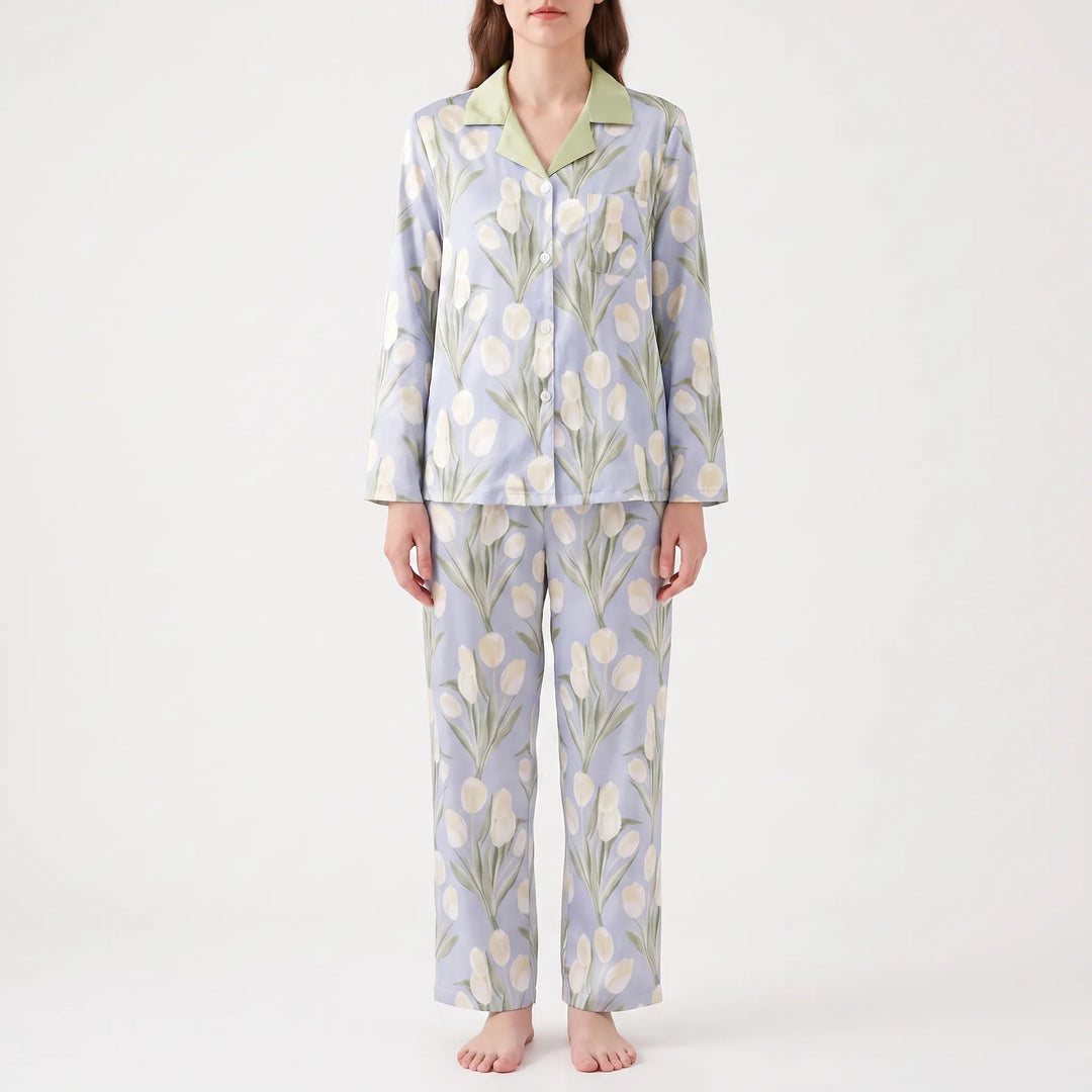 Front view of a model standing in the blue pyjama set with cream tulip print, green collar and wide straight trousers. 8
