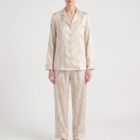 Another colourway for comparison: beige satin pyjama set with a soft marbled swirl pattern and white piping, shown from the front on a model. 9
