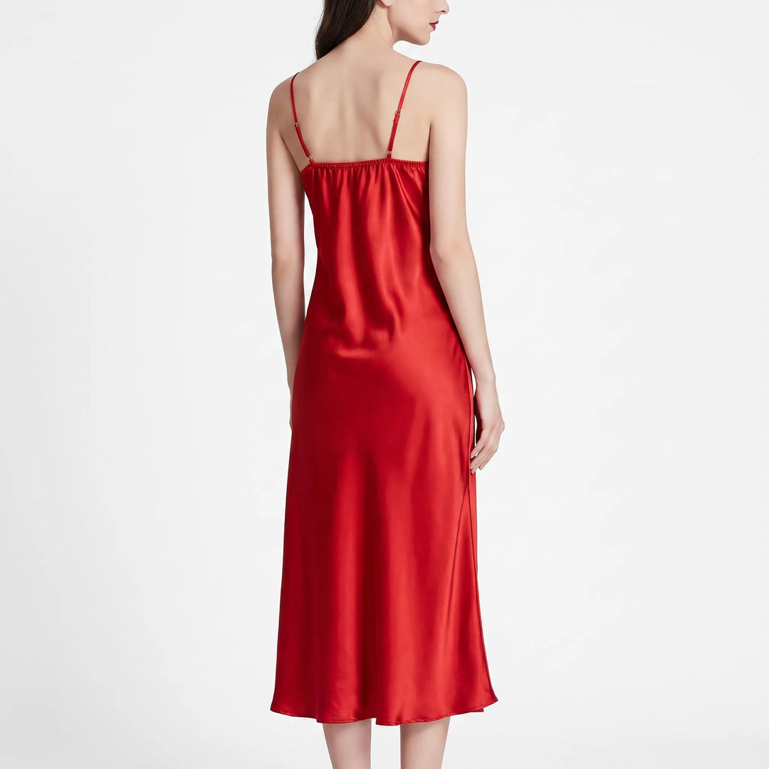 Back view of the red satin nightdress on a model, showing thin adjustable straps, gathered back neckline and flowing skirt. 3