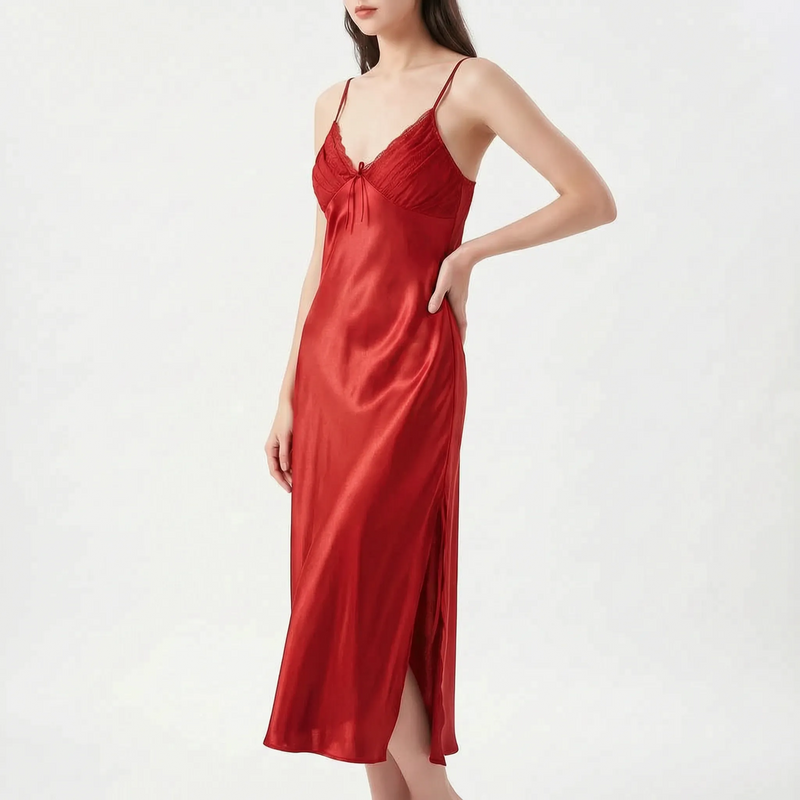 Model with hand on hip wearing the nightdress in deep red satin, with lace-trimmed pleated bodice and side slit. 8