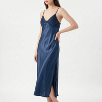Model with hand on hip wearing the nightdress in navy blue satin, with lace-trimmed pleated bodice, bow and side slit. 9