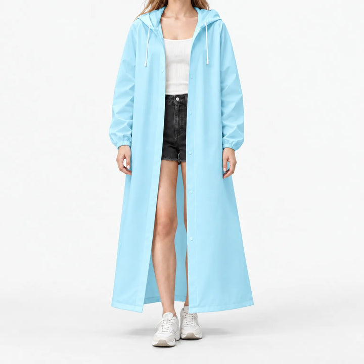 Studio front view of the light blue hooded raincoat worn open, with elastic cuffs and white drawstrings over a white top. 10