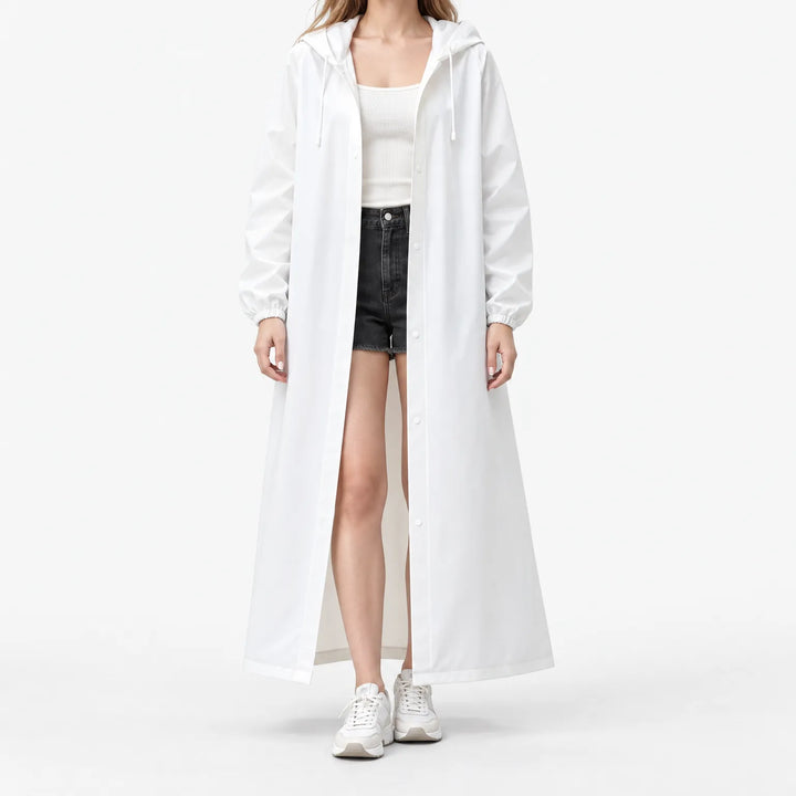 Studio front view of the white hooded raincoat worn open with snap buttons, elastic cuffs and drawstring hood over shorts. 2