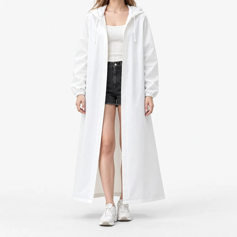 Studio front view of the white hooded raincoat worn open with snap buttons, elastic cuffs and drawstring hood over shorts. 2